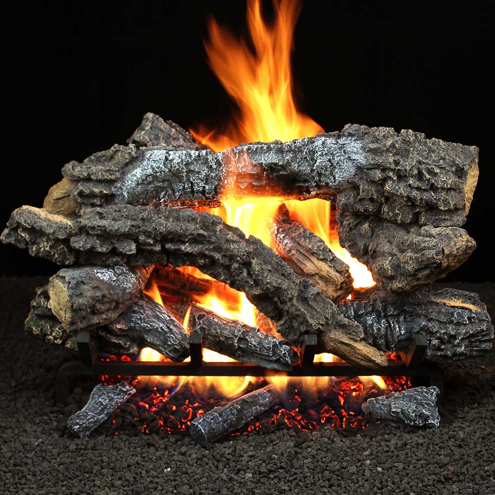 Vented gas log set with stacked dark logs and visible orange flames