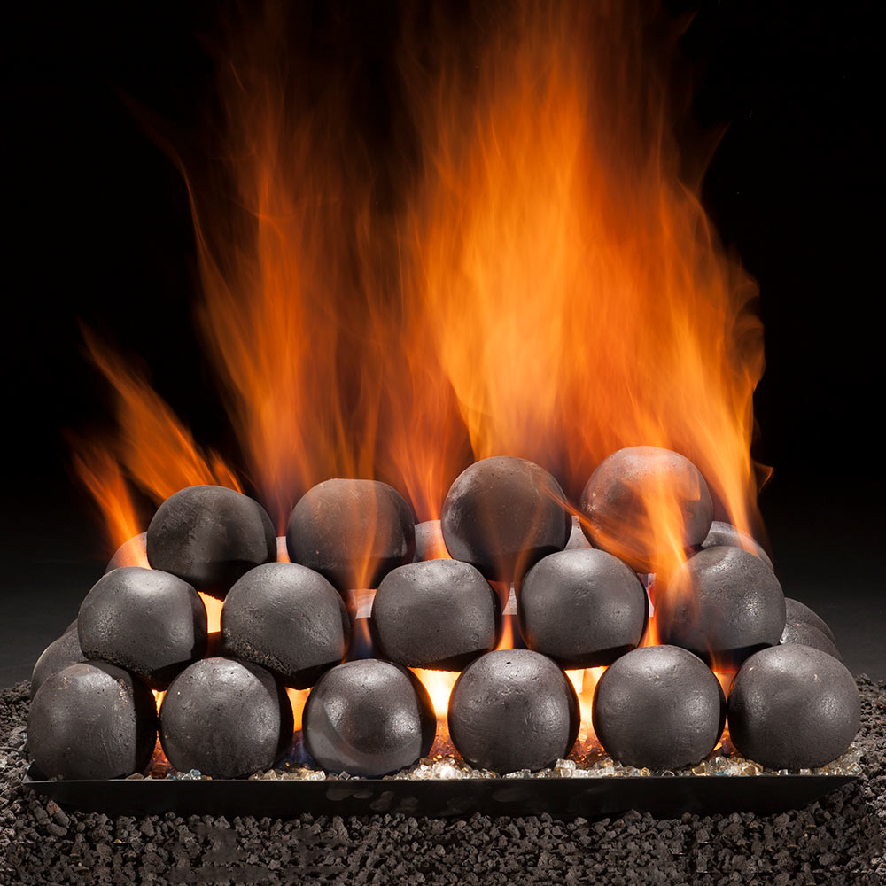 Vented gas burner pan with matte black cannon balls and visible orange flames