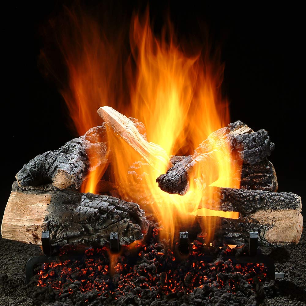 Vented gas log set with glowing flames over charred logs and a black rock bed