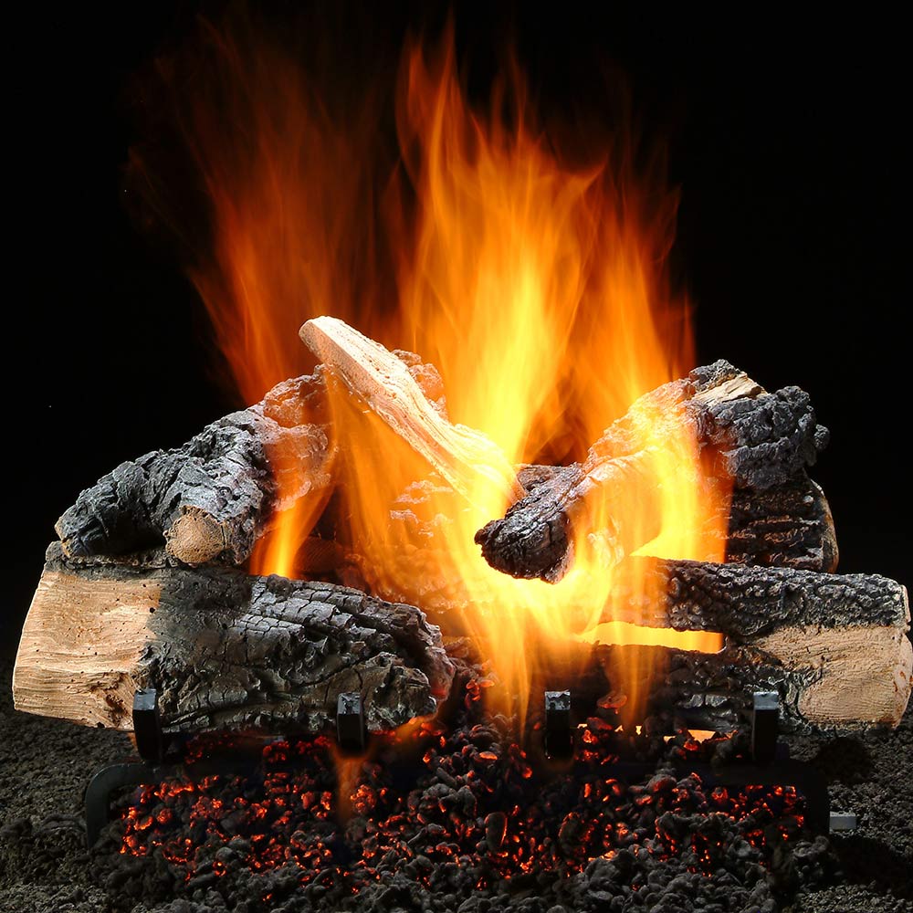 Gas fire logs with burning flames, glowing embers, and charred wood pieces