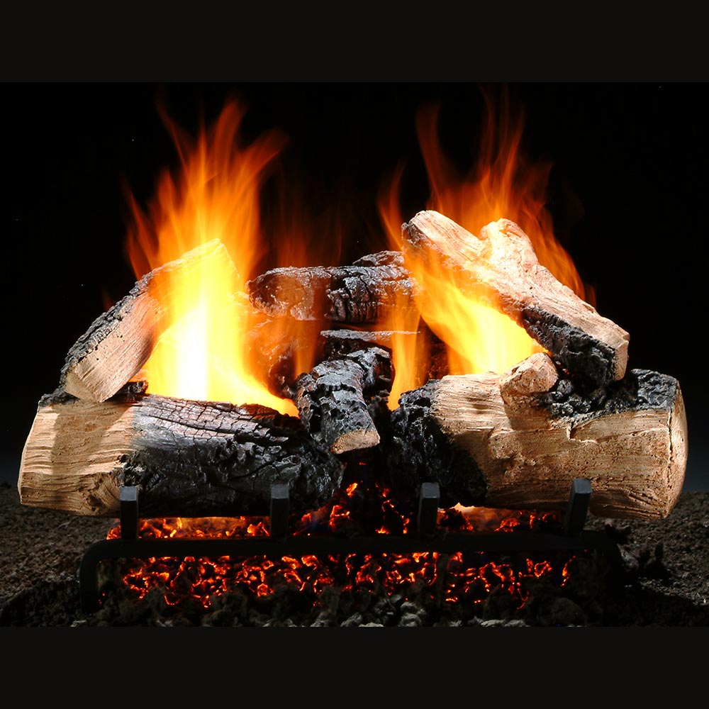 Vented gas log set with burning flames among dark charred logs
