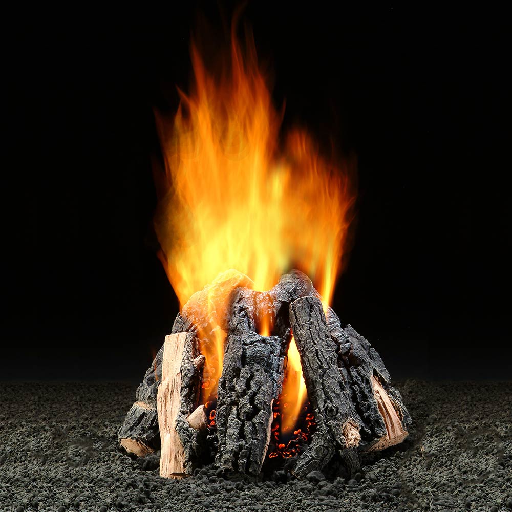 Gas log burner with glowing embers and orange flames over dark split logs