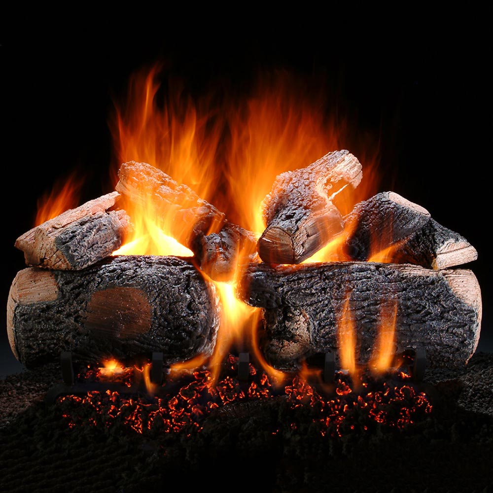 Vented gas log set with glowing flames and stacked charred log pieces