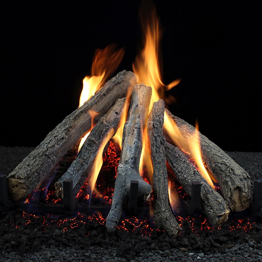 Vented gas logs with glowing embers and tall orange flames, stacked in a teepee