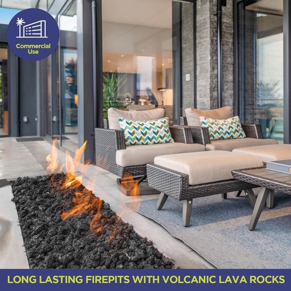 Black lava rocks in an outdoor firepit with visible flames