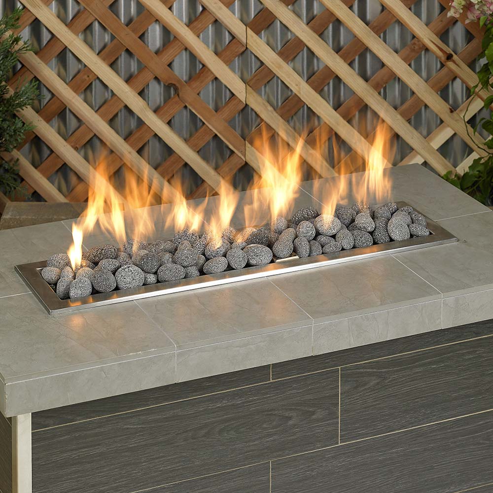 Gray lava fire glass stones with flames behind and above tray
