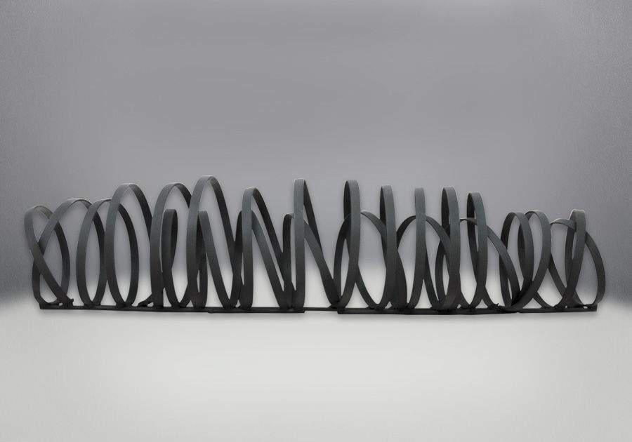 Black metal fireplace fire art with stacked circular ring loops