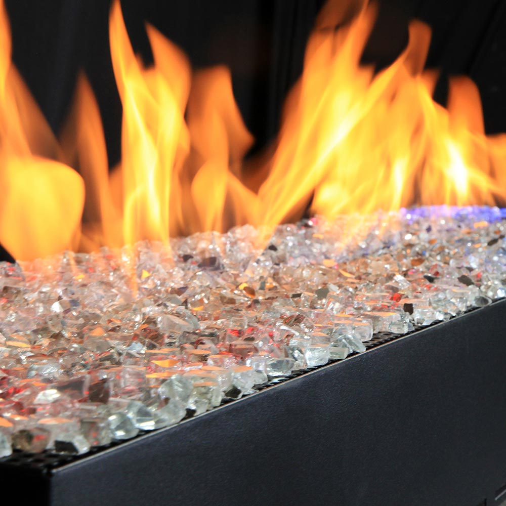 Glass-rock linear gas burner with bright flames and dark firebox edge