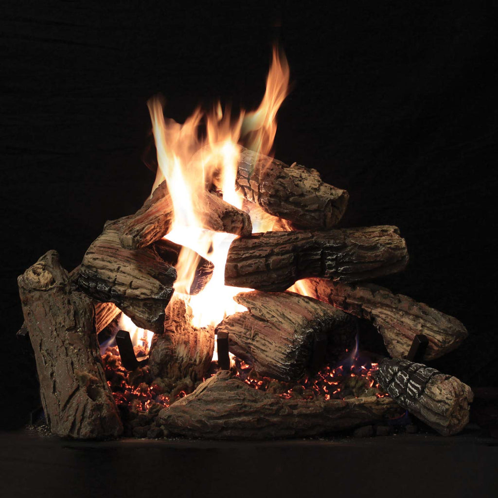 Burning ceramic fiber logs with tall orange flames over dark base