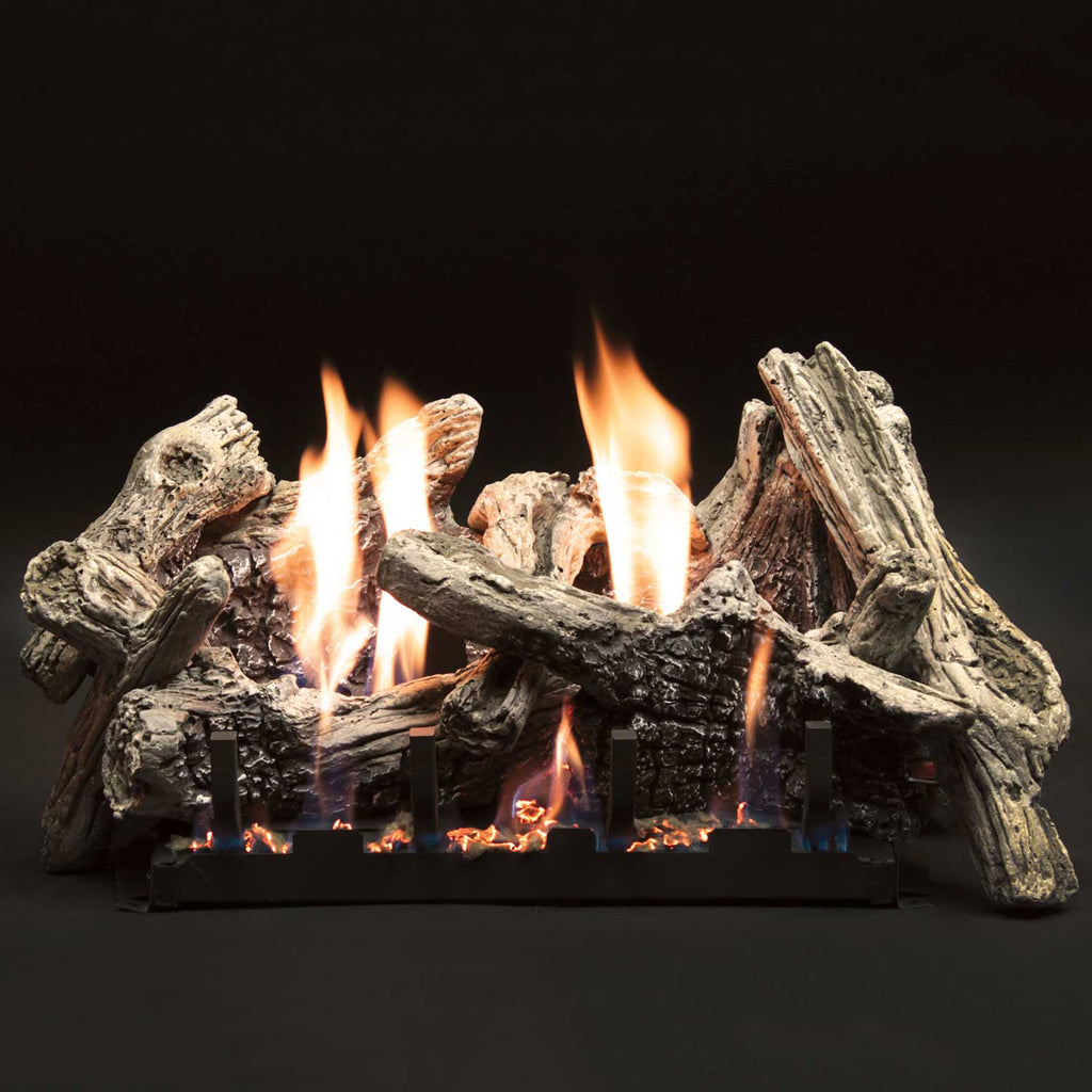 Gas fireplace log set with burning flames and driftwood-style logs