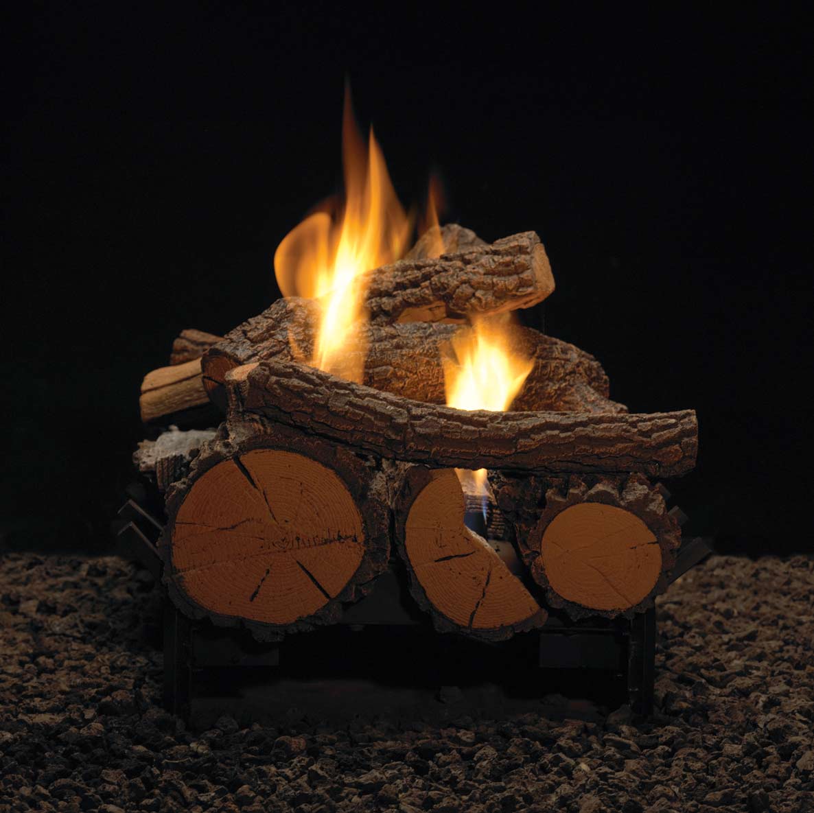 Ventless fireplace interior showing burning logs over an ember bed