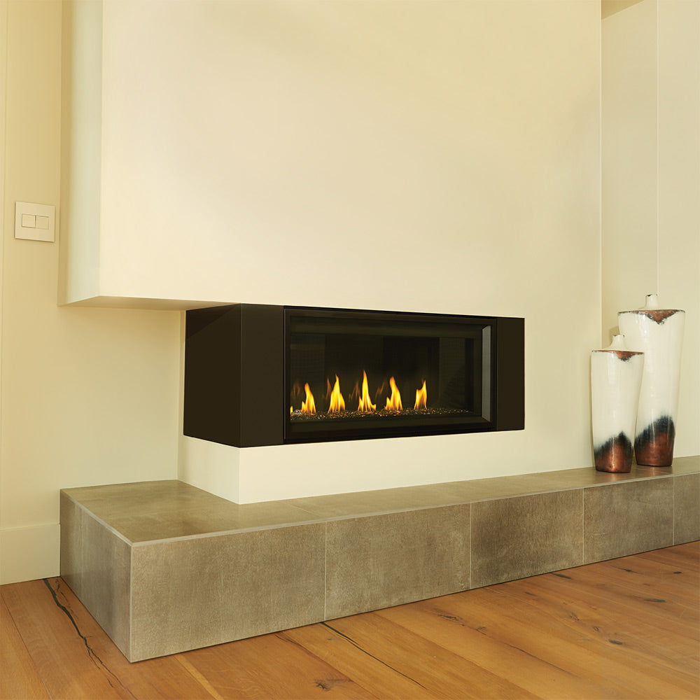 Corner gas fireplace with black firebox and glowing flames over a log-style firebed