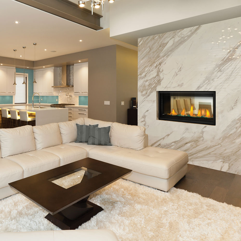 Direct vent gas fireplace with burning logs in a wall opening and black frame