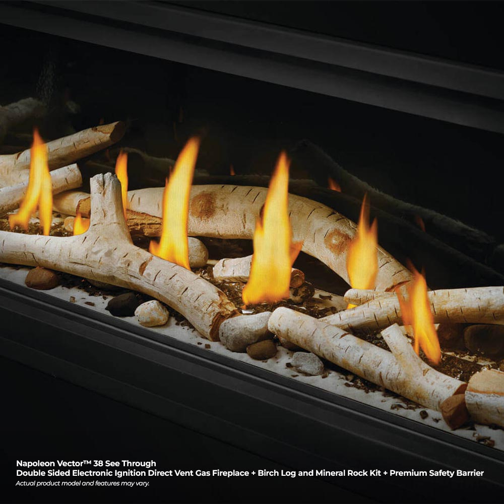 Gas fireplace burner with birch logs and glowing flames over light mineral rock