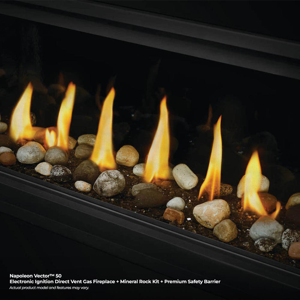 Direct vent fireplace with glowing flames over mineral rock media and small stones