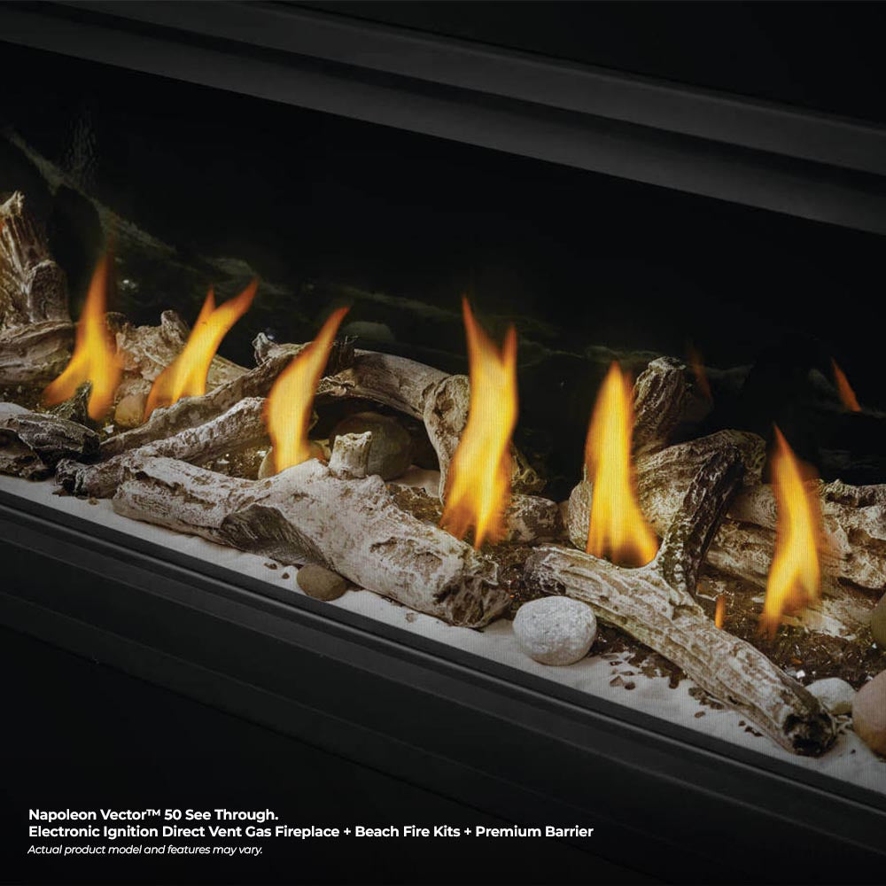 Gas fireplace burner with glowing flames over rock and log embers