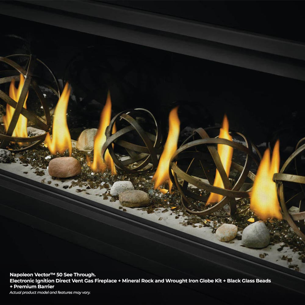 Close-up of gas fireplace flames with wrought iron globe decor and rocks