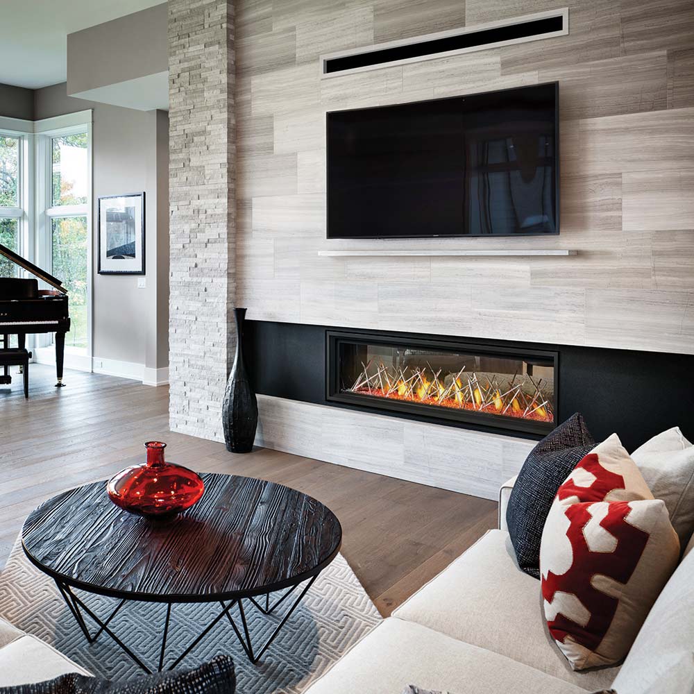 Gas fireplace insert with burning logs and yellow flames set in a stone and black surround