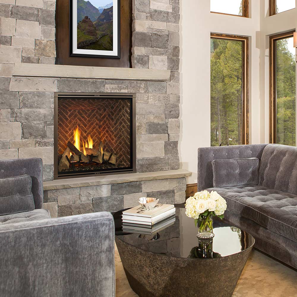 Direct vent gas fireplace with herringbone brick interior panel and burning flames