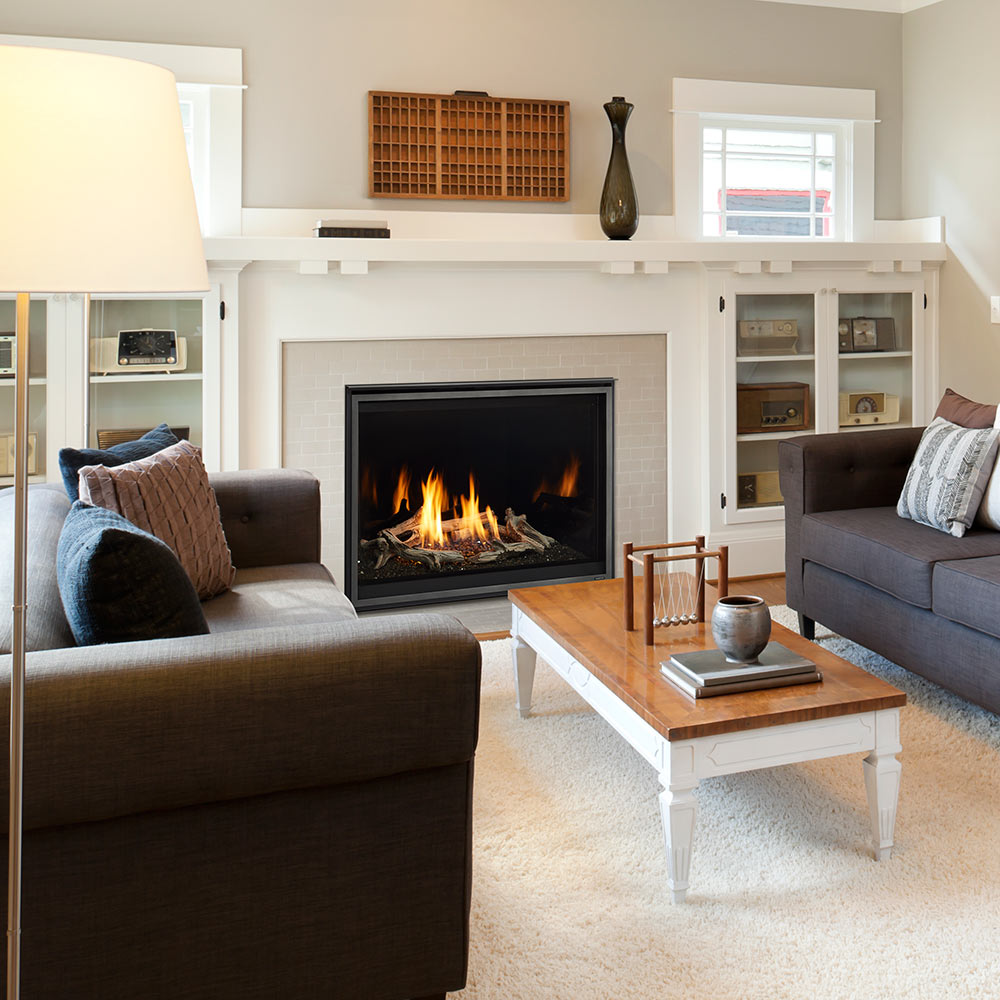 Direct-vent gas fireplace with burning flames in black glass firebox within white surround