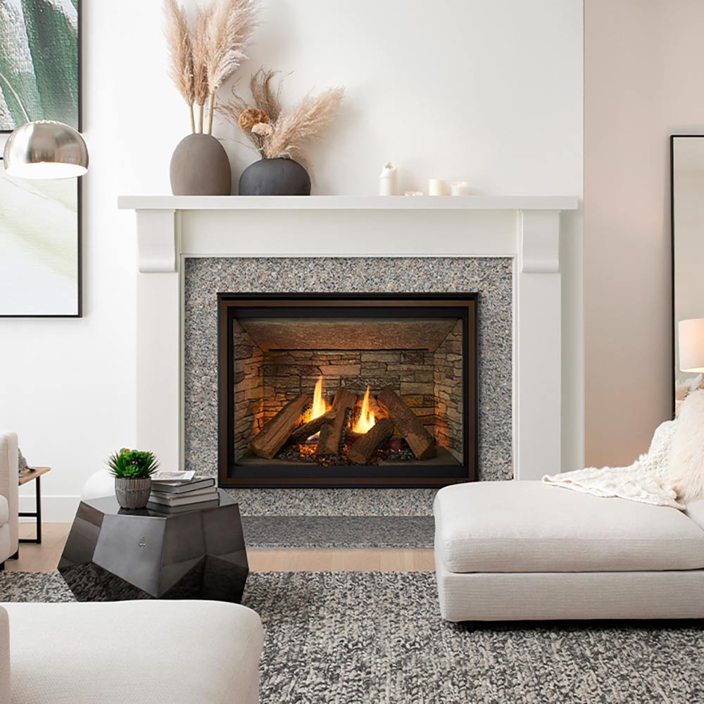 Built-in gas fireplace with black frame and burning logs in a stone surround