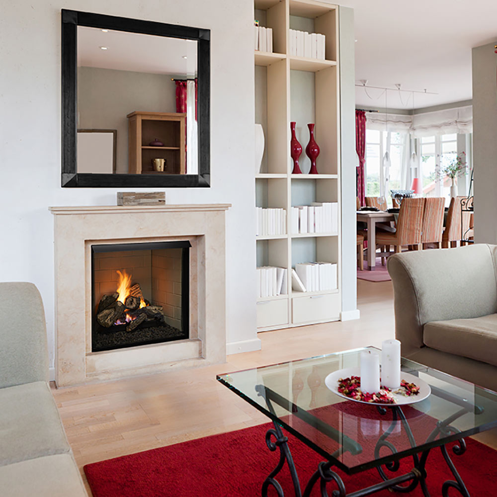 Vent-free gas log set burning inside a white fireplace surround
