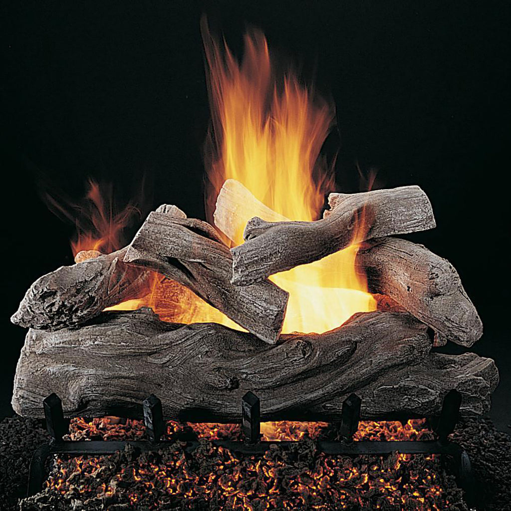 Gas fireplace log set with stacked manzanita logs and visible flames