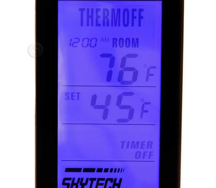 Backlit thermostat timer display on fireplace remote, glowing blue screen