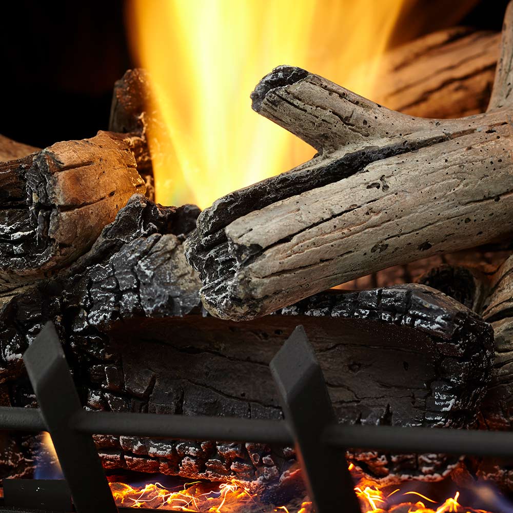 Vent-free gas log set close-up with split logs and tall orange flames