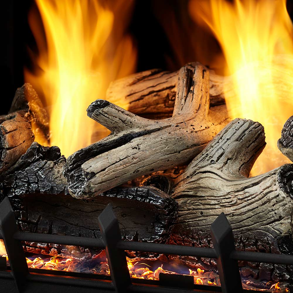Vent-free gas log set front view with glowing logs behind black burner grate
