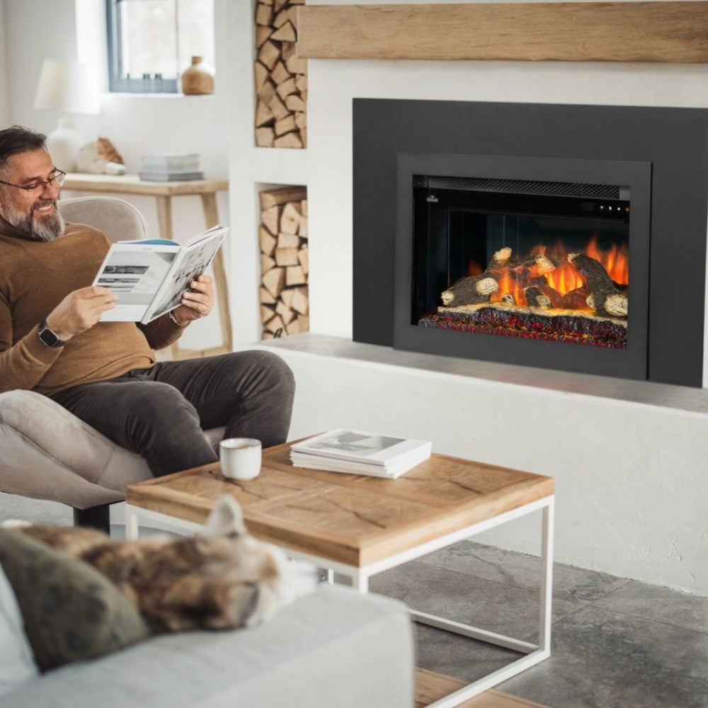Black electric fireplace insert installed in a wall, showing faux logs and flames