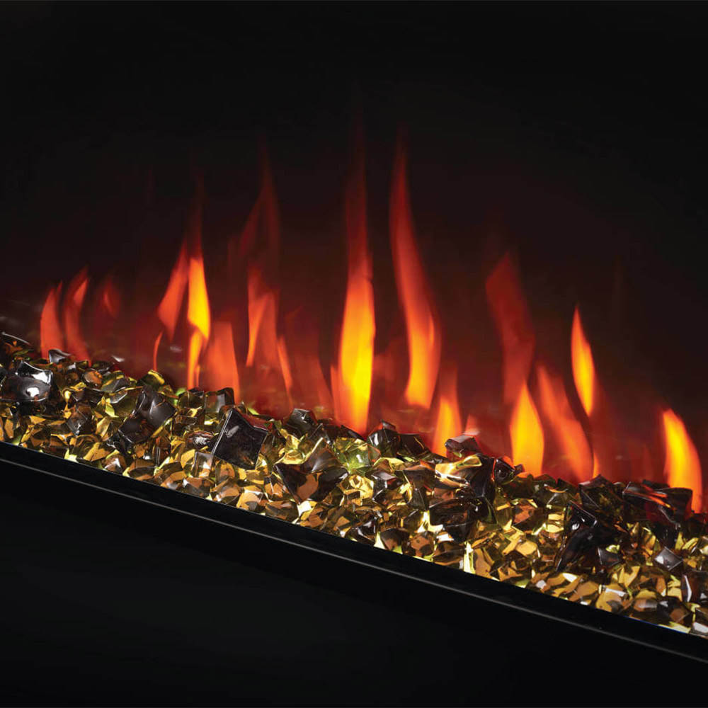 Electric fireplace interior with gold-like crystal bed and tall orange flame effect.