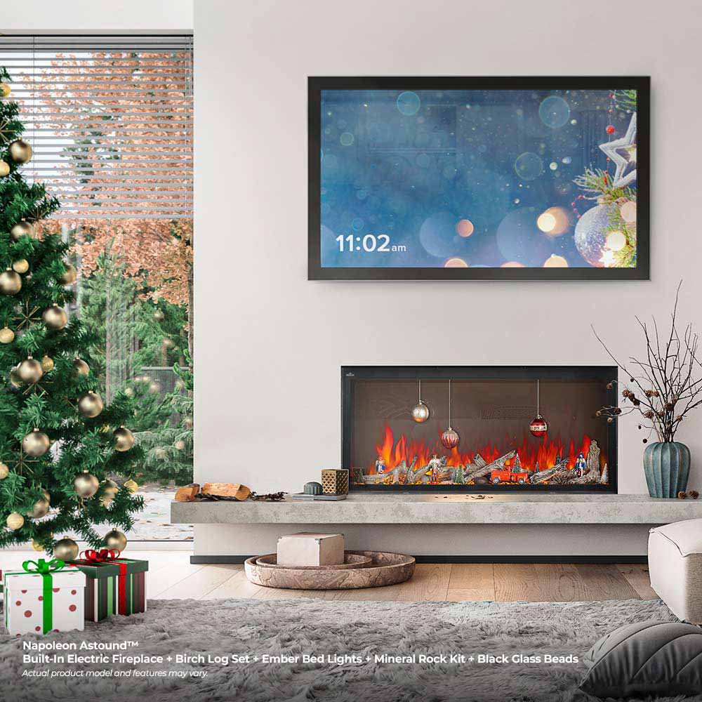 Built-in electric fireplace with black frame and red flames with hanging ornaments