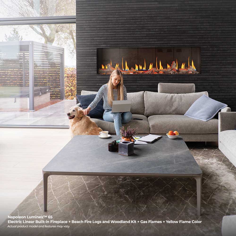 Built-in linear electric fireplace with orange flames in a modern stone wall surround