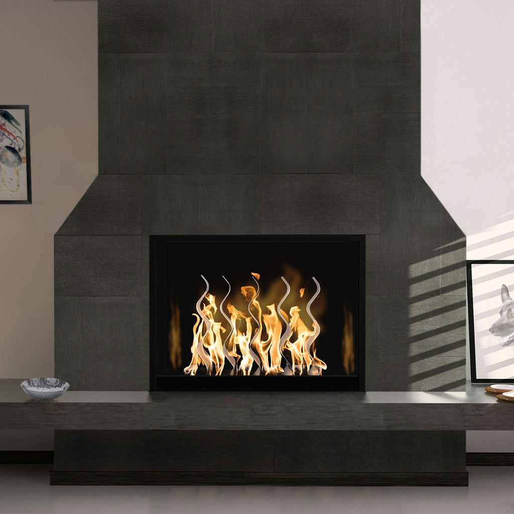 Outdoor stainless steel fireplace with open flame in a dark firebox