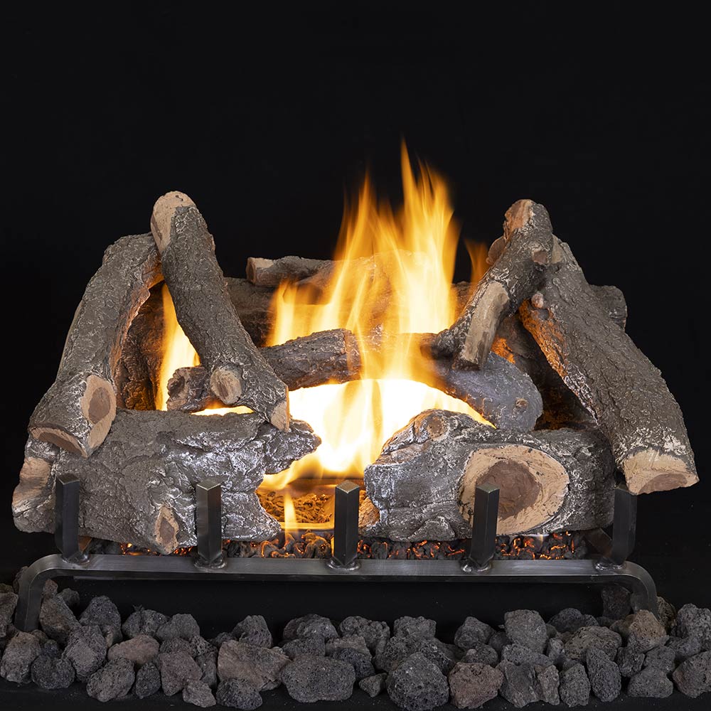 Vented ceramic fiber gas log set with glowing embers and flames, dark charred logs.