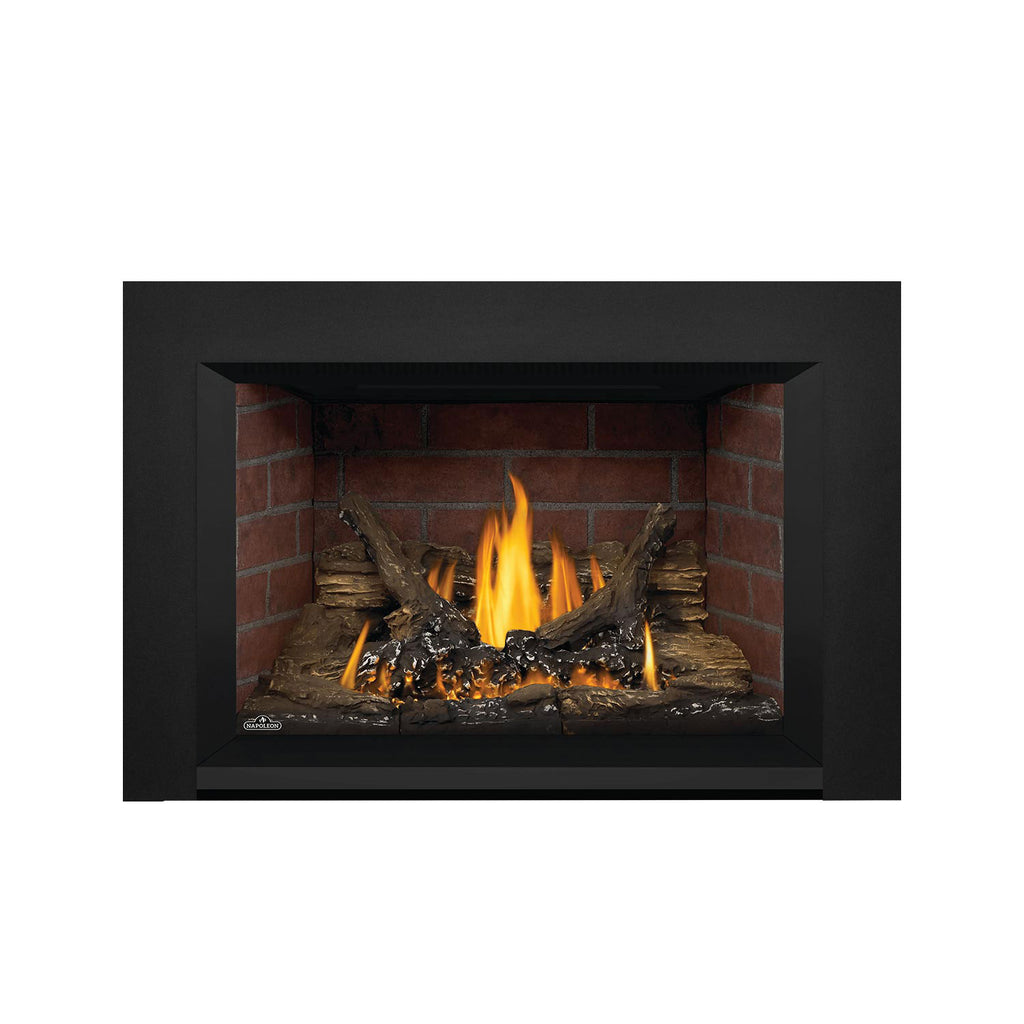 Direct vent gas fireplace insert with dark frame and bright yellow flames on logs