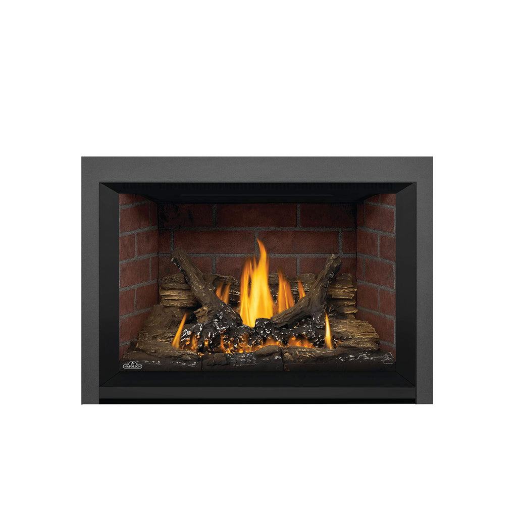 Gas fireplace insert with dark gray trim, brick interior, burning flames, and log set.