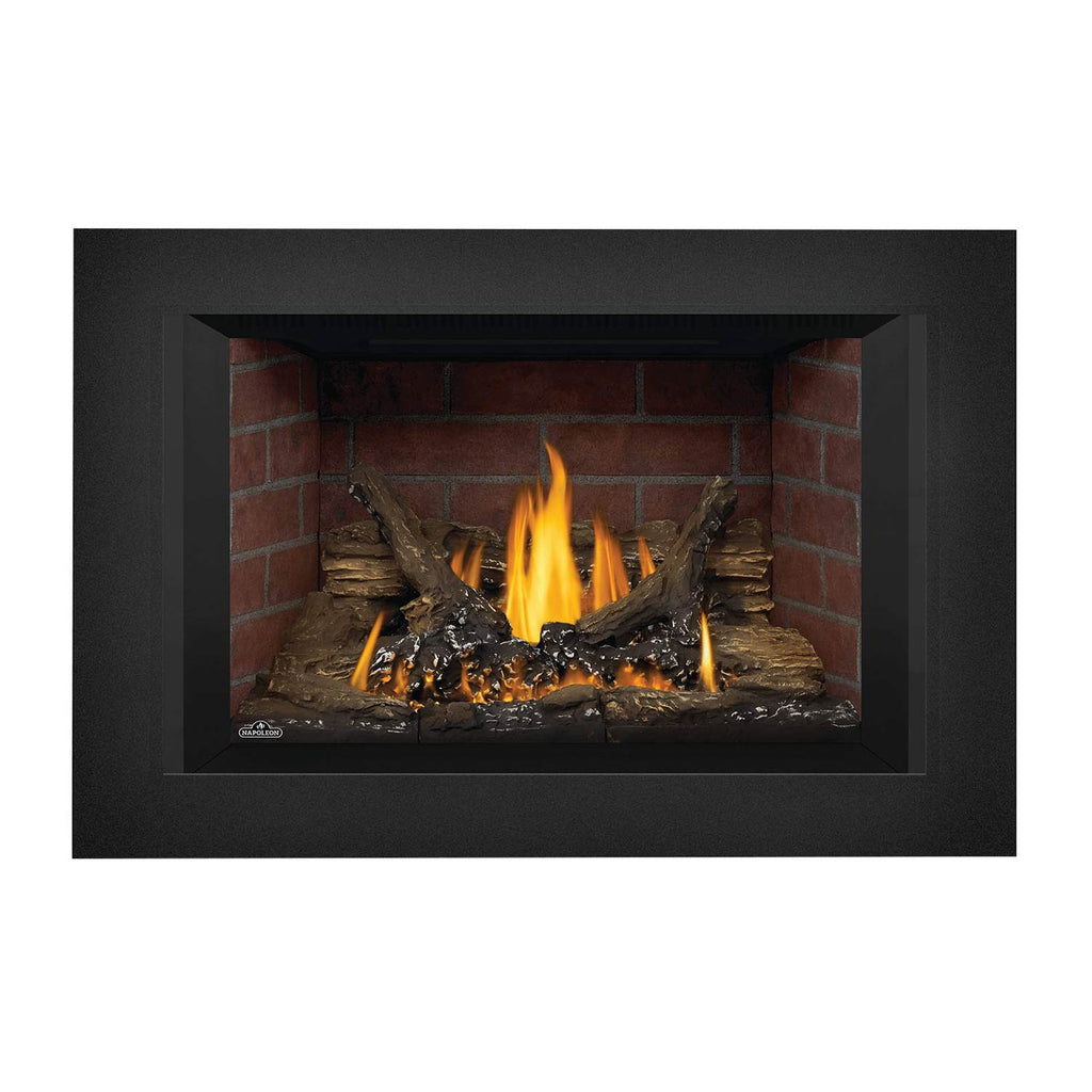 Direct vent gas fireplace insert with bright flames, stacked logs, and red brick backing, dark surround