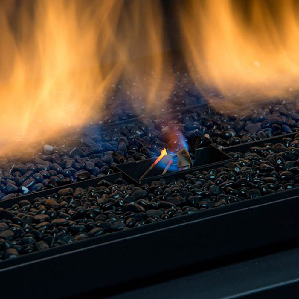 Close-up of gas fireplace fireglass and rock media with bright flame jets