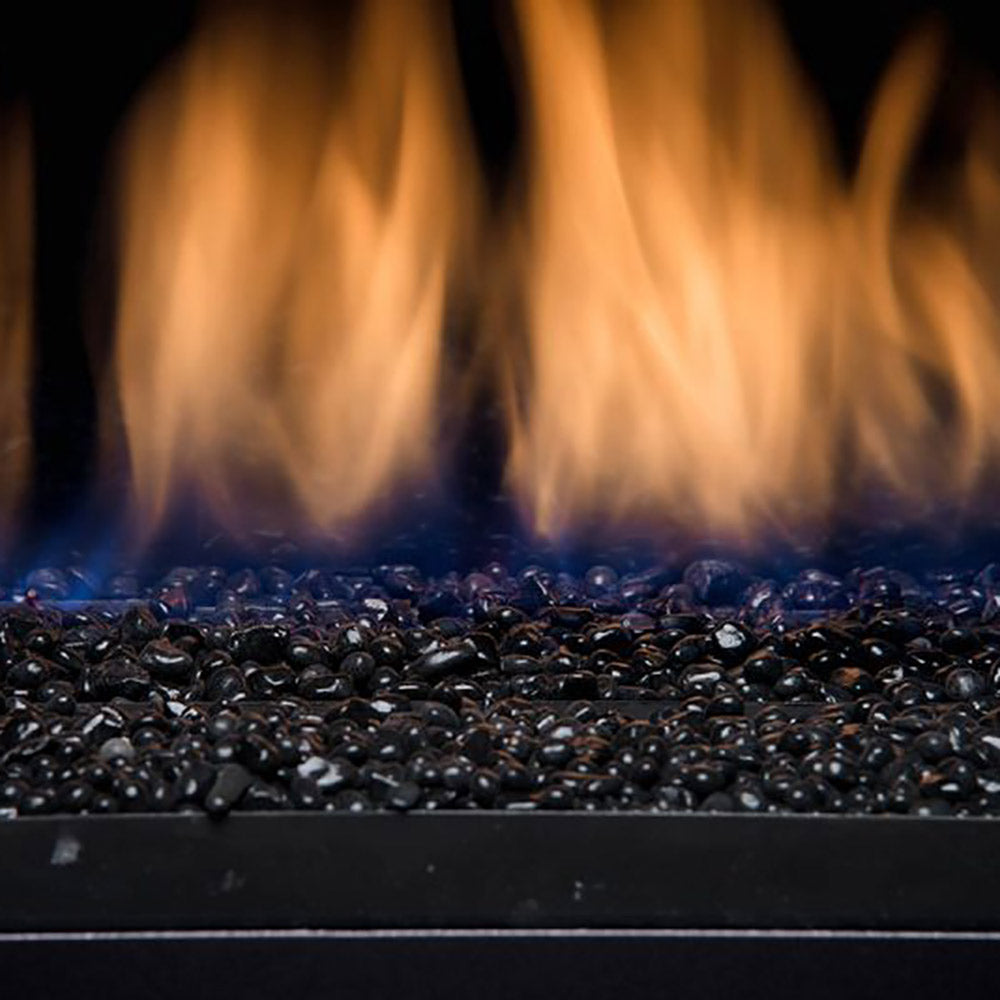 Gas fireplace fireglass and rock media bed with orange flames in black tray