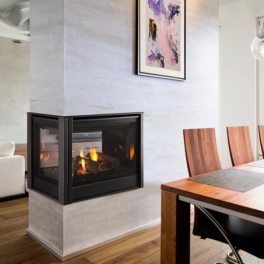 Multi-sided gas fireplace with black frame and visible flames behind glass doors