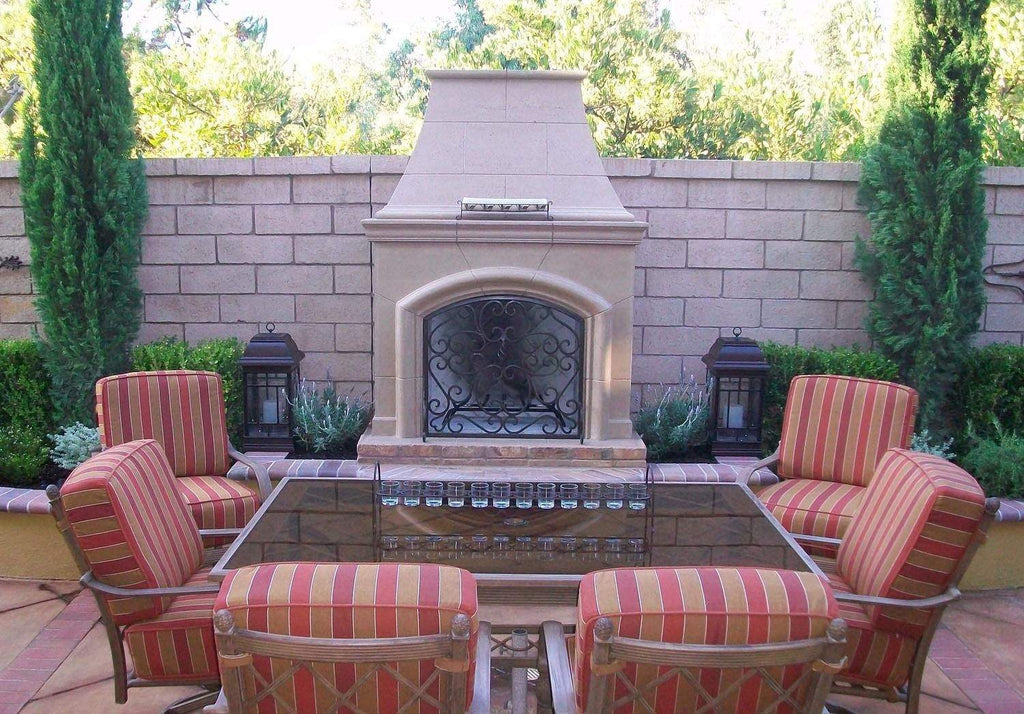 White outdoor gas fireplace with arched firebox and metal mesh screen
