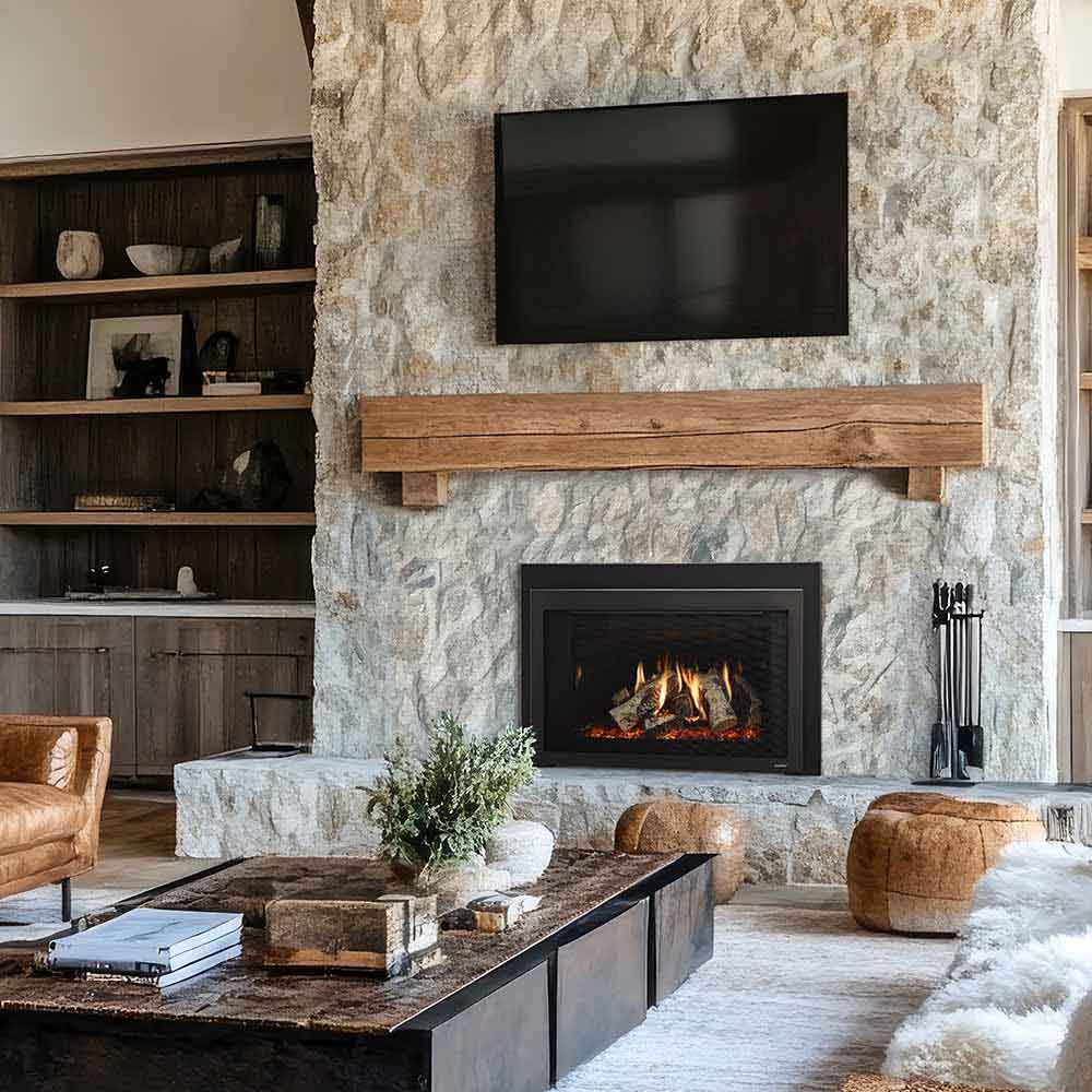 Light stone mantel direct vent gas fireplace insert with burning logs behind glass