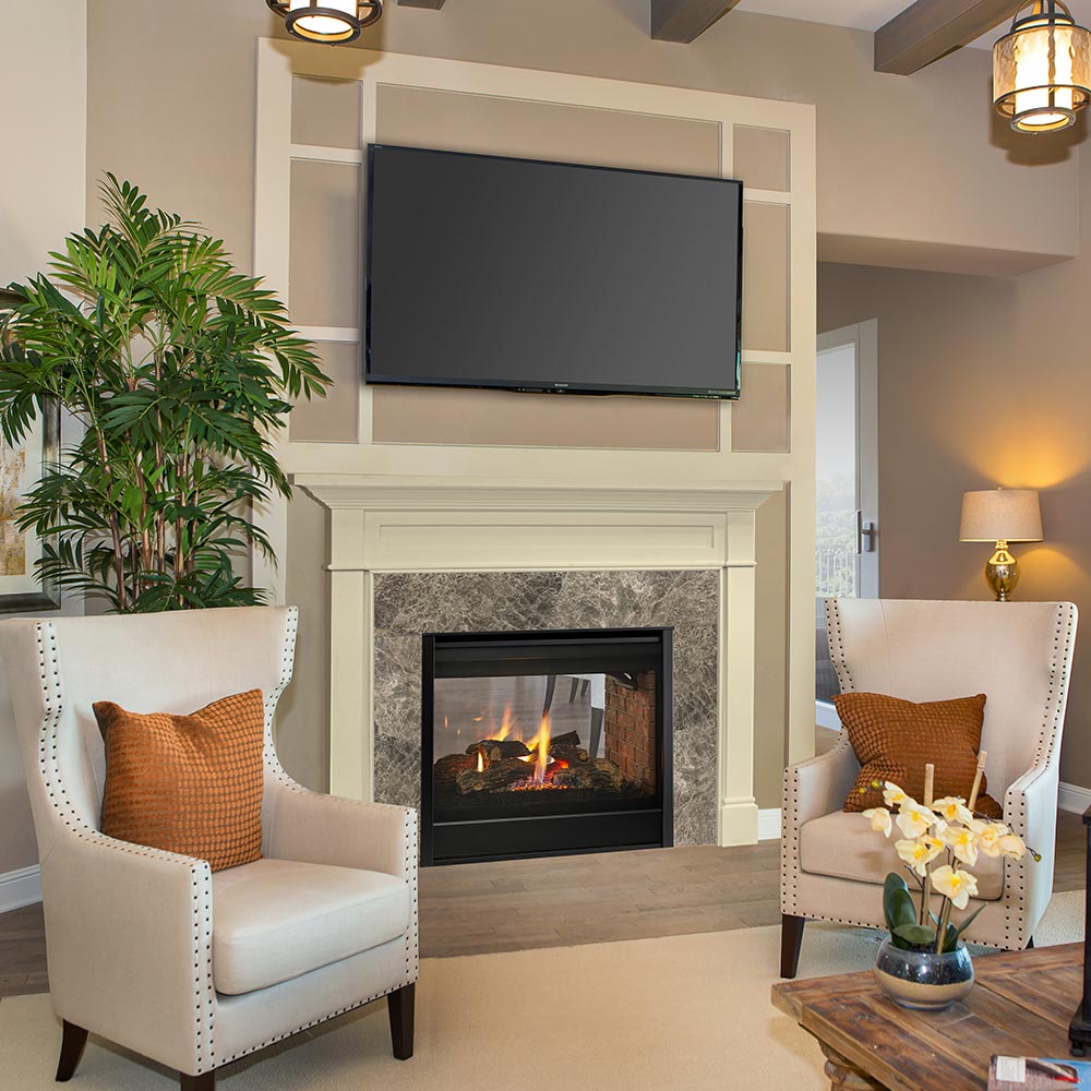 Direct vent gas fireplace insert in dark frame with flame view through glass