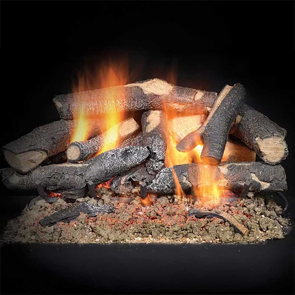 Indoor vented gas log set with glowing embers and visible flames on dark logs