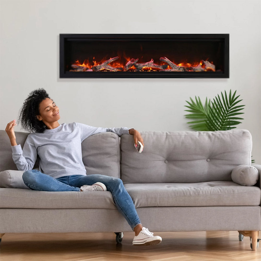 Electric fireplace insert with glowing flame display in a black frame