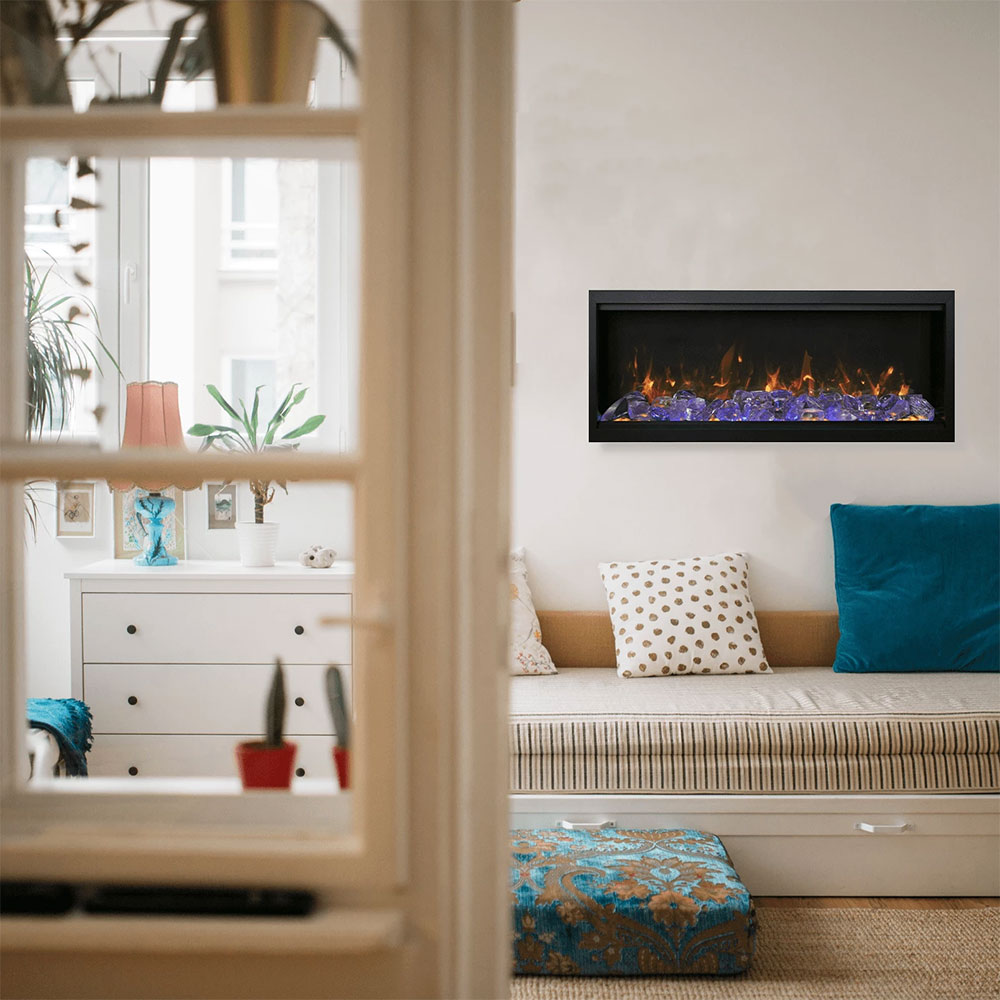 Built-in electric fireplace with black frame and glowing flames behind glass