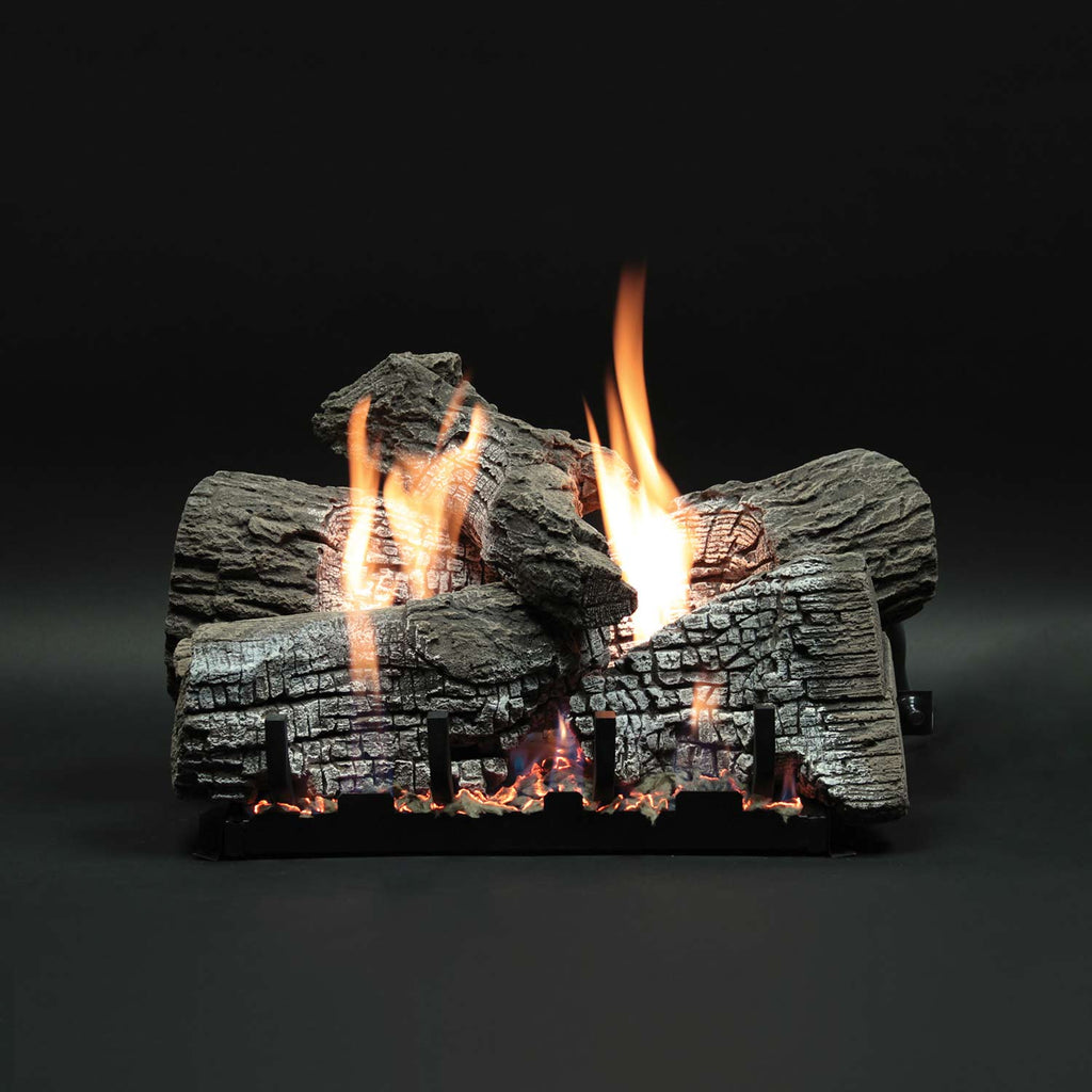 Stacked refractory fireplace logs with bright flames over dark base grate