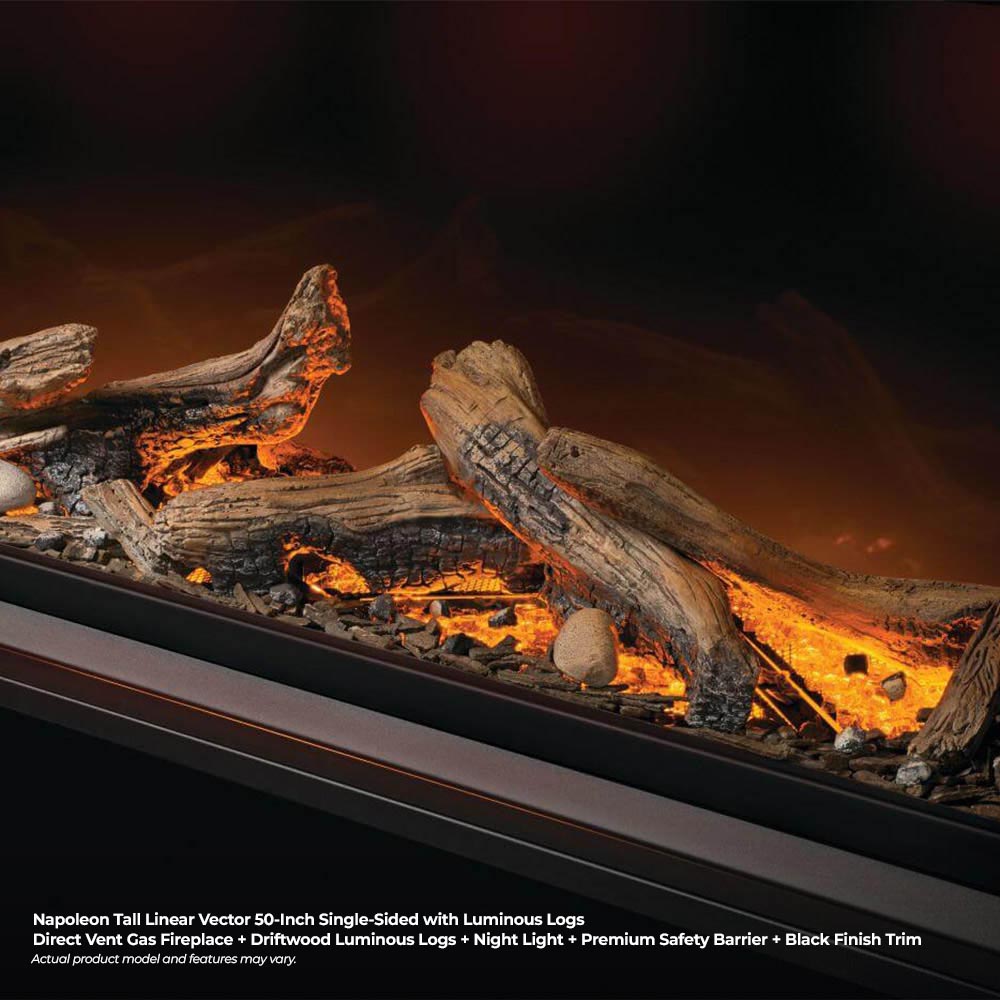 Close-up of luminous gas fireplace logs with orange flames behind glass